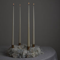 gold candle stick on xmas wreath with candles